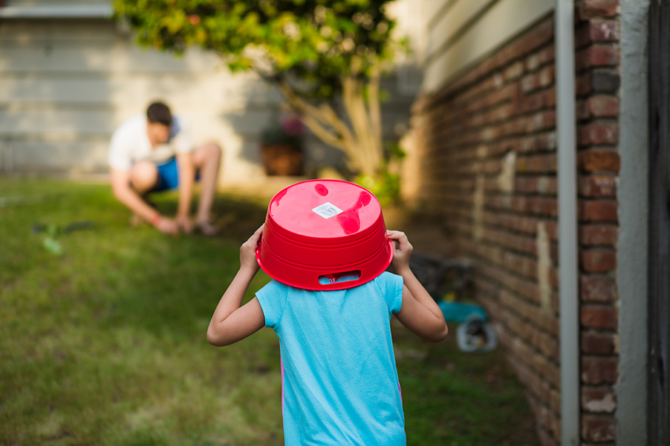 child with bucket on head - Documentary Family Photography