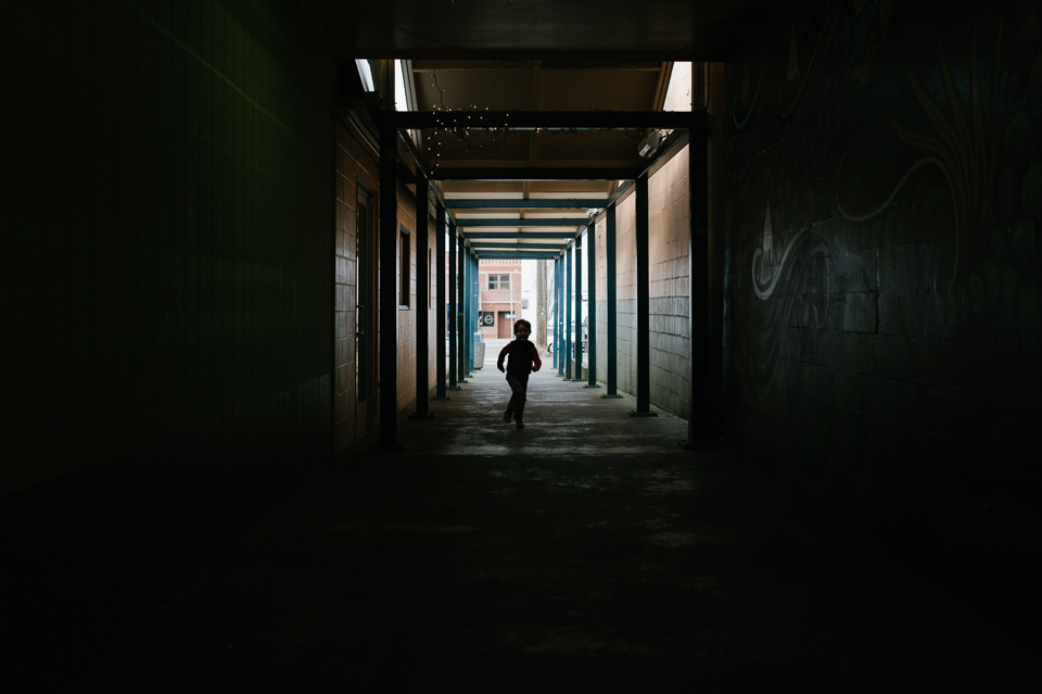 boy running through tunnel - Documentary Family Photography