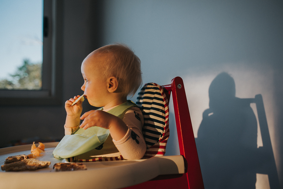baby eats snack - Documentary Family Photography