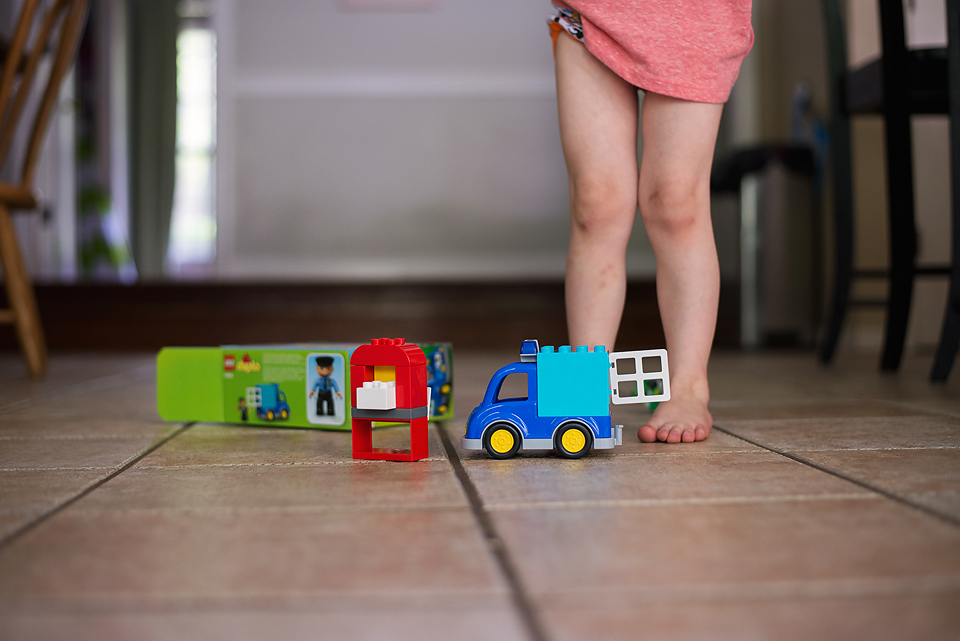 toys on floor and kid's feet - Documentary Family Photography