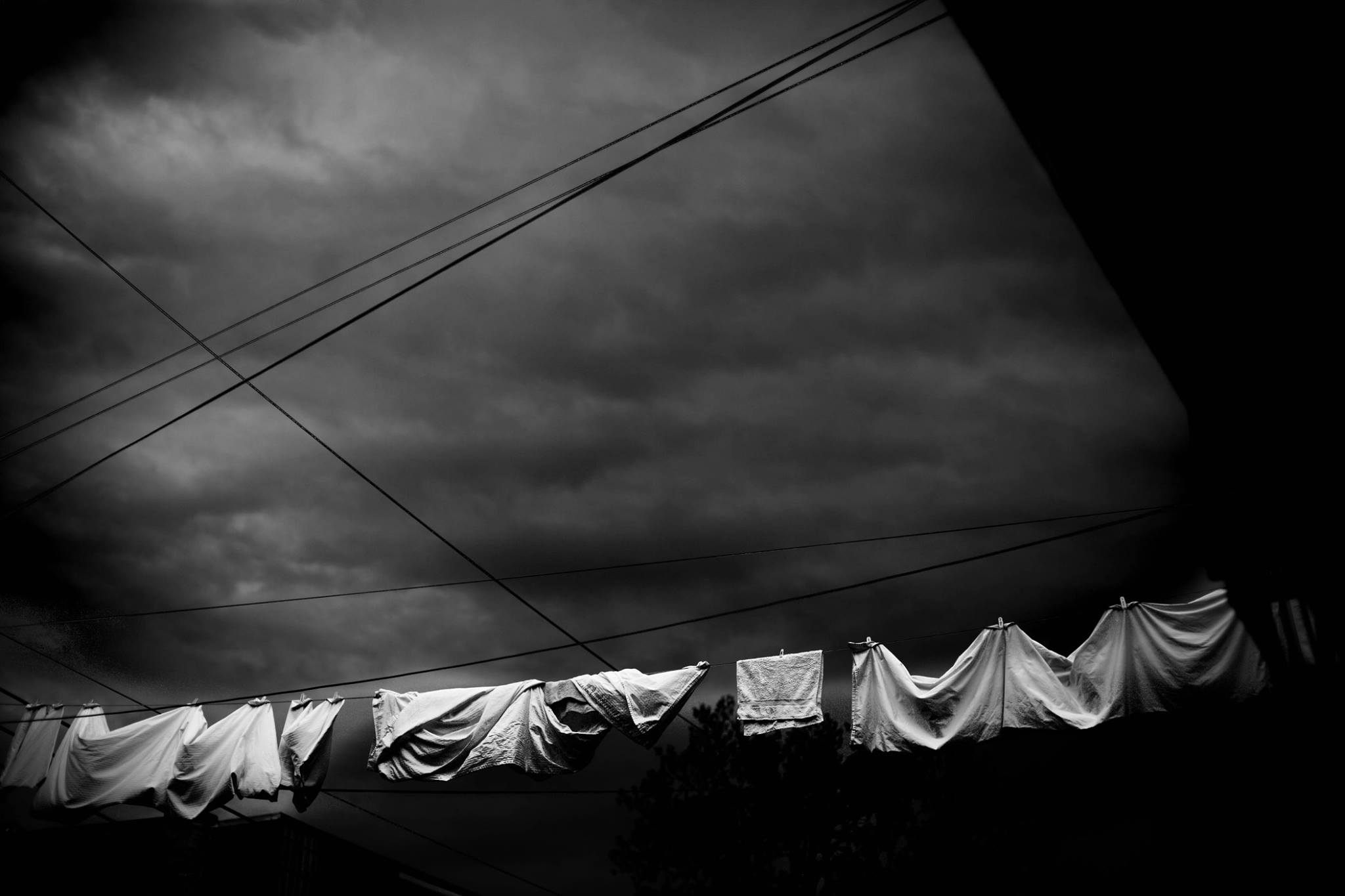 laundry drying on line before storm - Documentary Family Photography