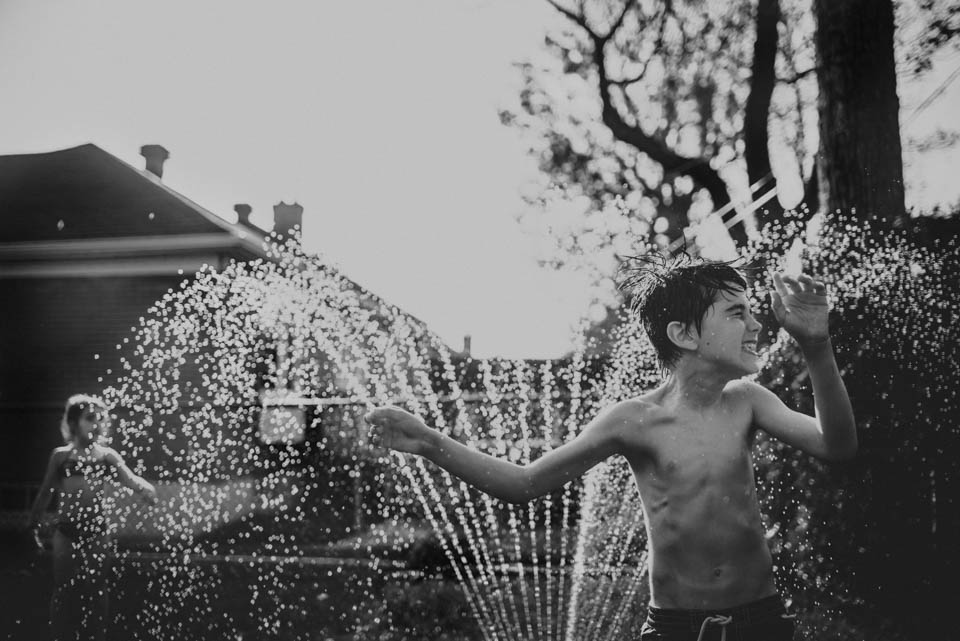 boy in sprinkler - Documentary Family Photography