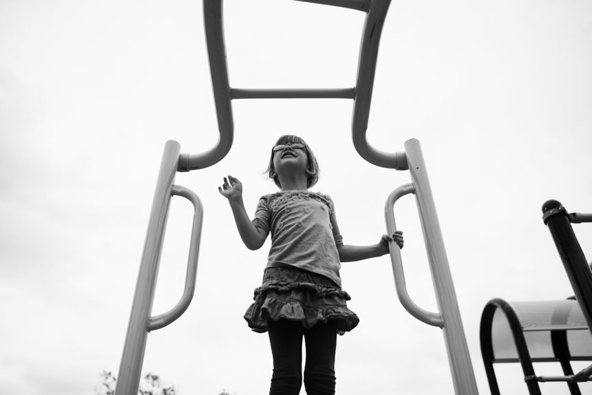 girl on monkey bars - Documentary Family Photography