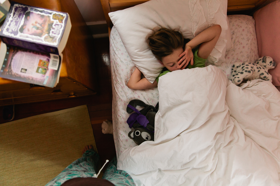 girl stretching in bed - Documentary Family Photography