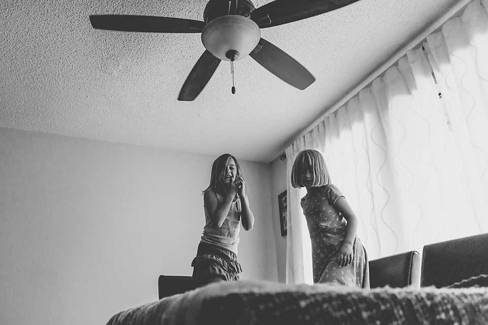 girls giggling in bedroom - Documentary Family Photography