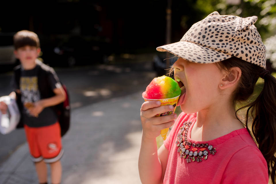 girl in hat eating snow cone - Documentary Family Photography