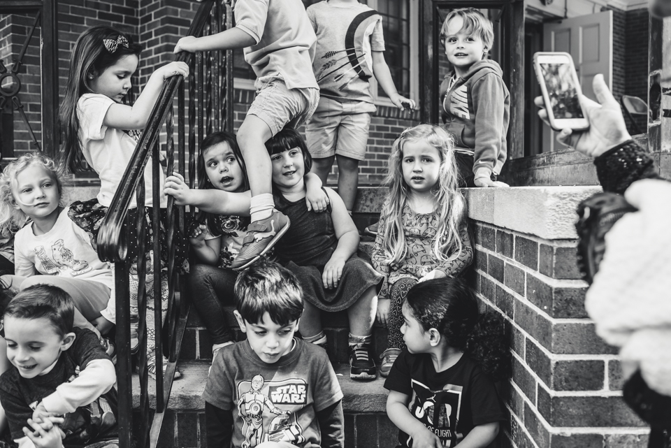 kids gathered on front stoop - Documentary Family Photography