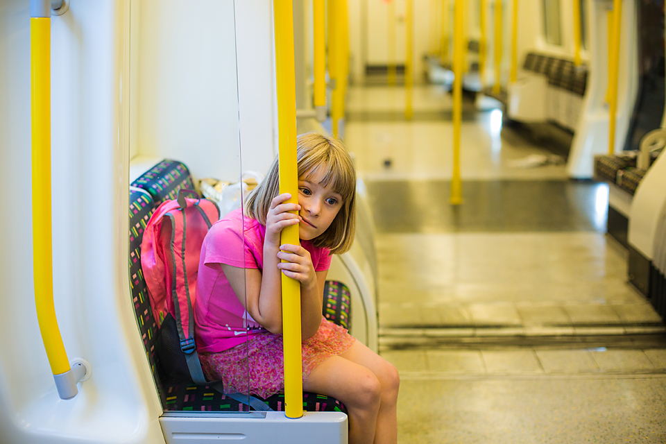 tired child on tram - Documentary Family Photography