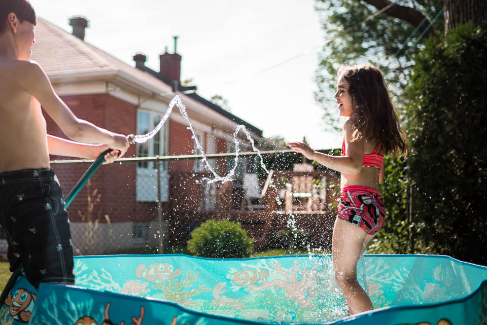 kids playing in hose - Documentary Family Photography