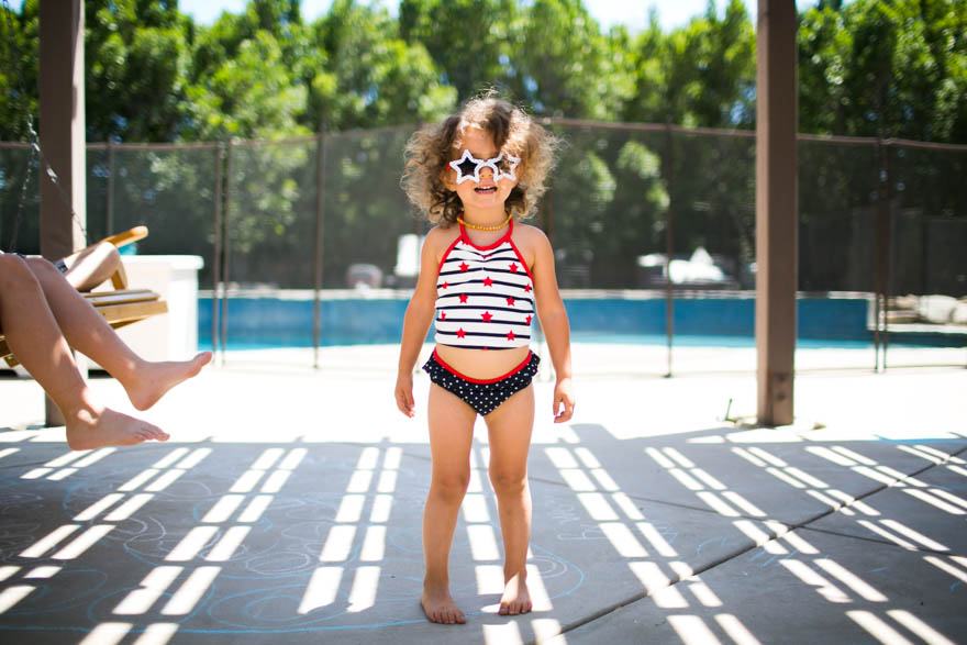Girl in bathing suit and sun glasses - Documentary Family Photography