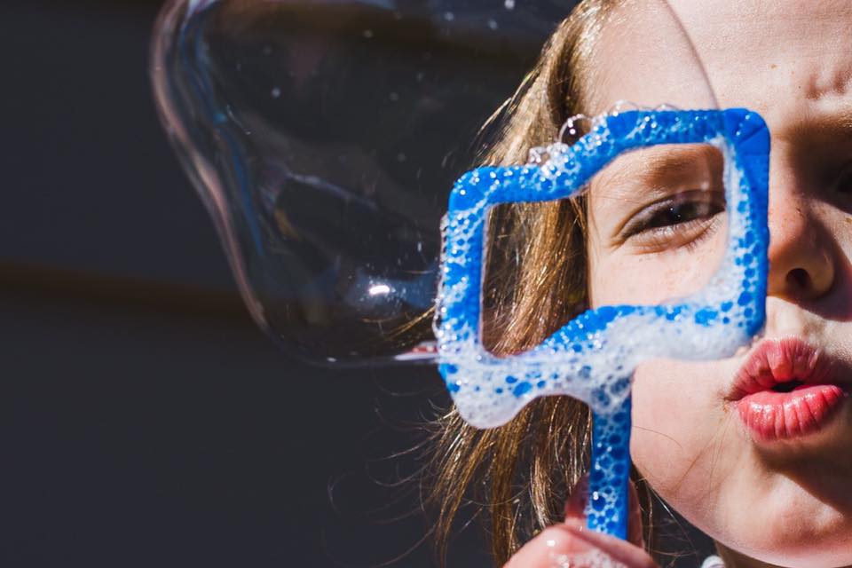 girl blowing bubbles - Documentary Family Photography