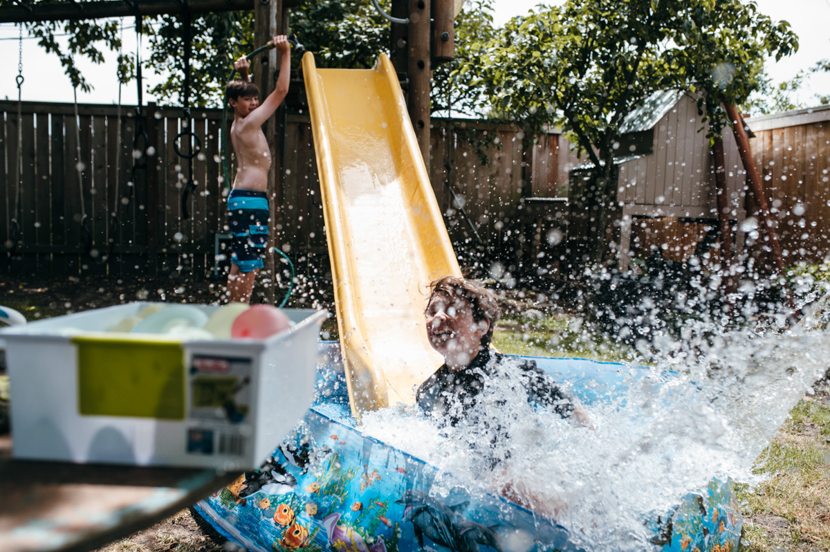 kids with slide and wading pool - Documentary Family Photography