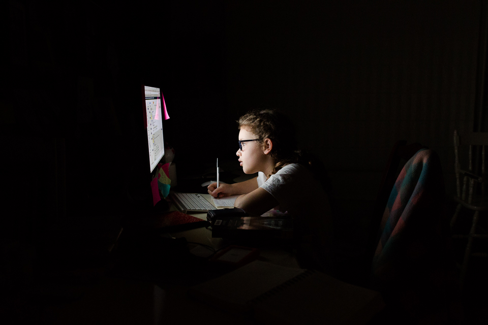 girl at computer screen in dark room - Documentary Family Photography