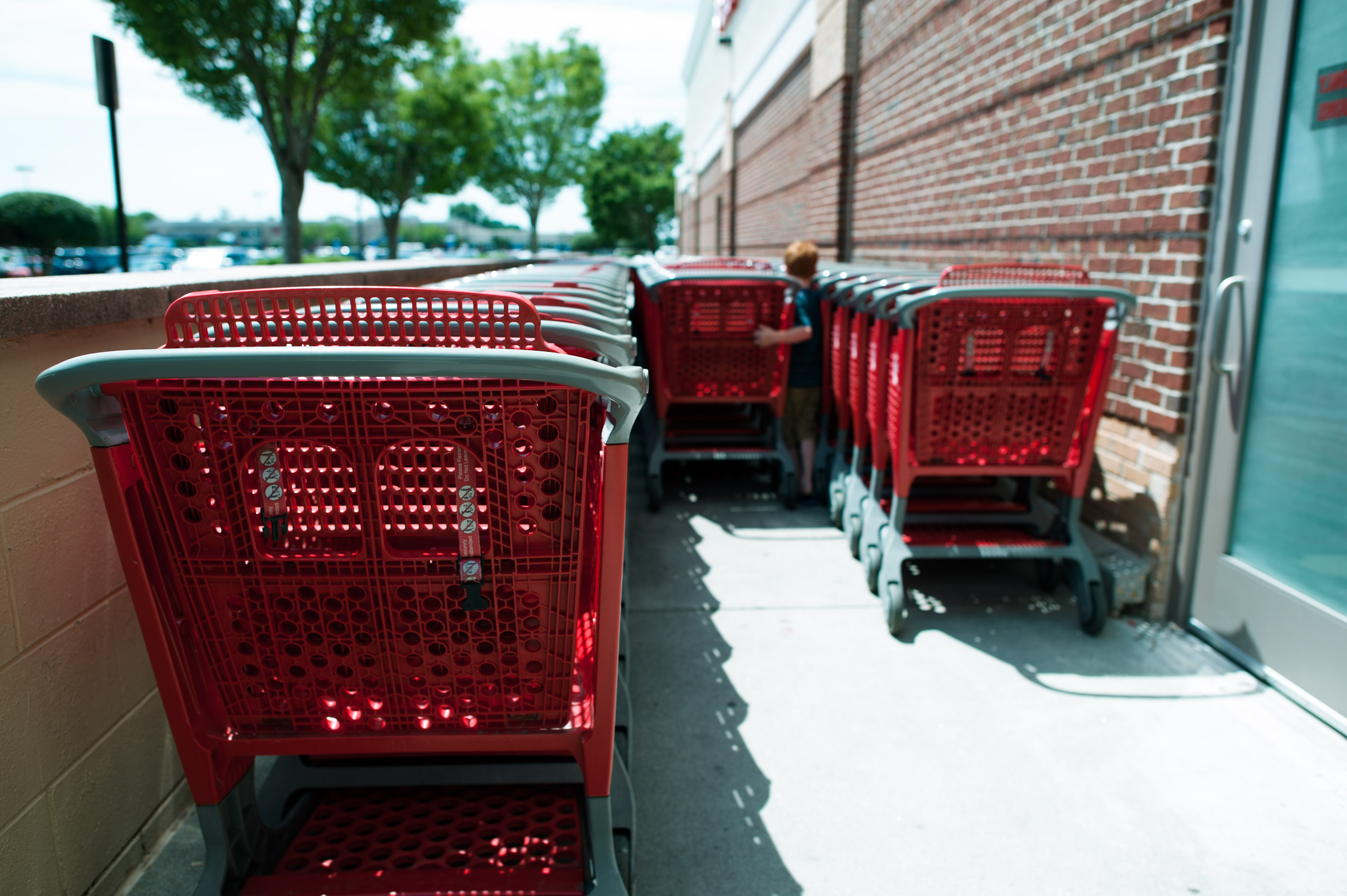 Boy at shopping carts - Documentary Family Photography