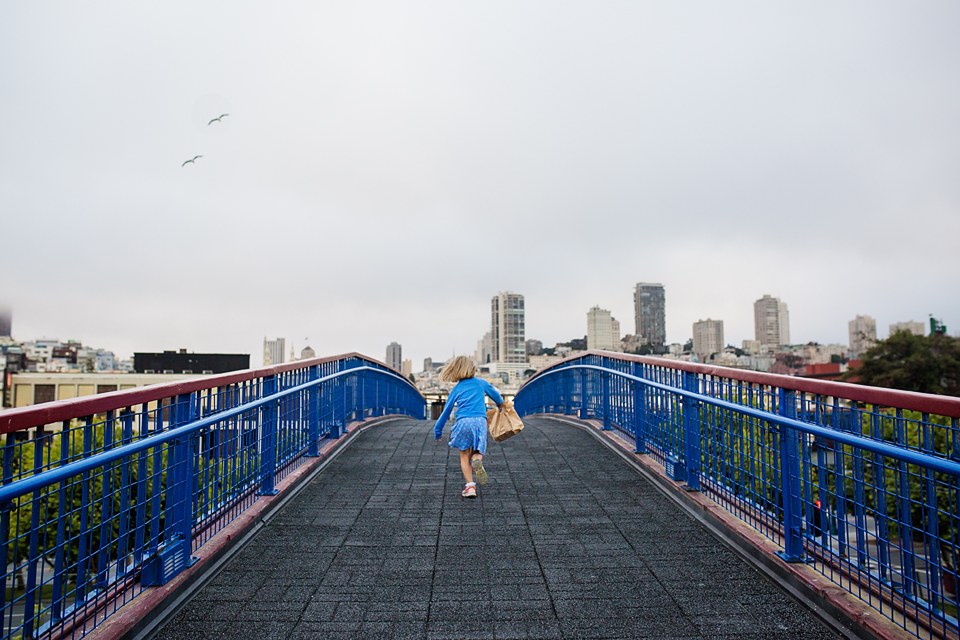 girl runs across bridge - Documentary Family Photography