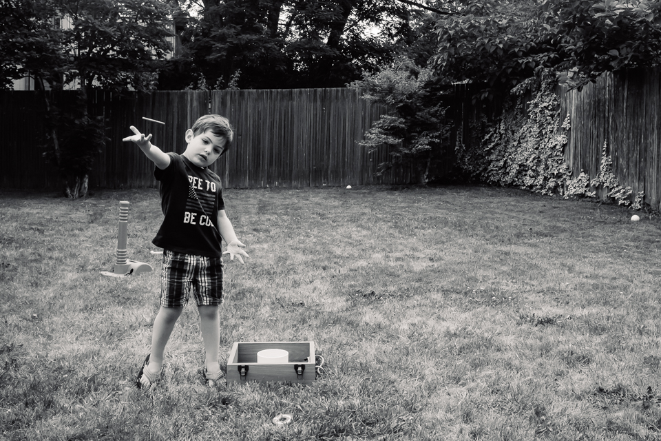 boy plays yard game - Documentary Family Photography