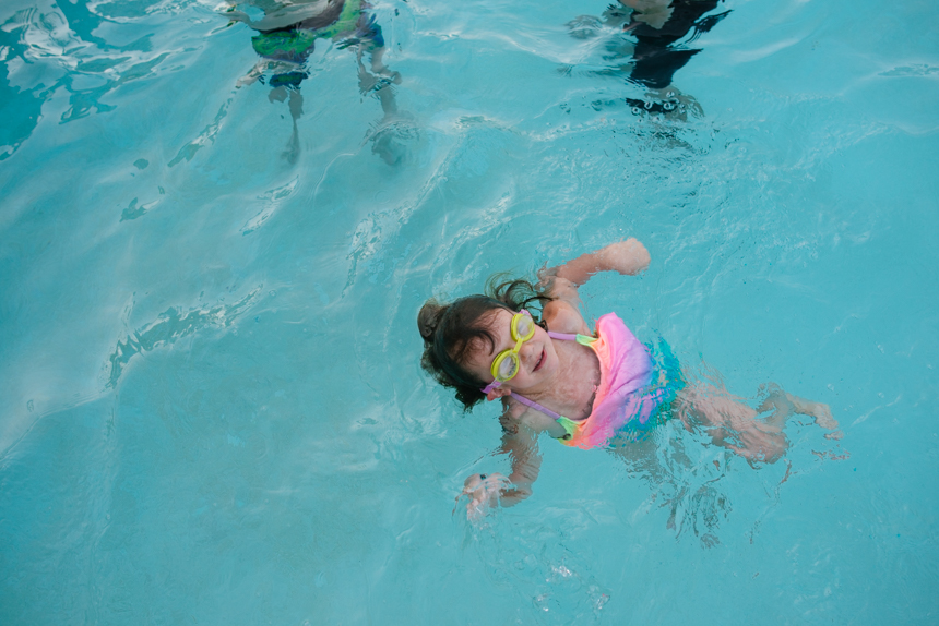 child swims in pool - Documentary Family Photography