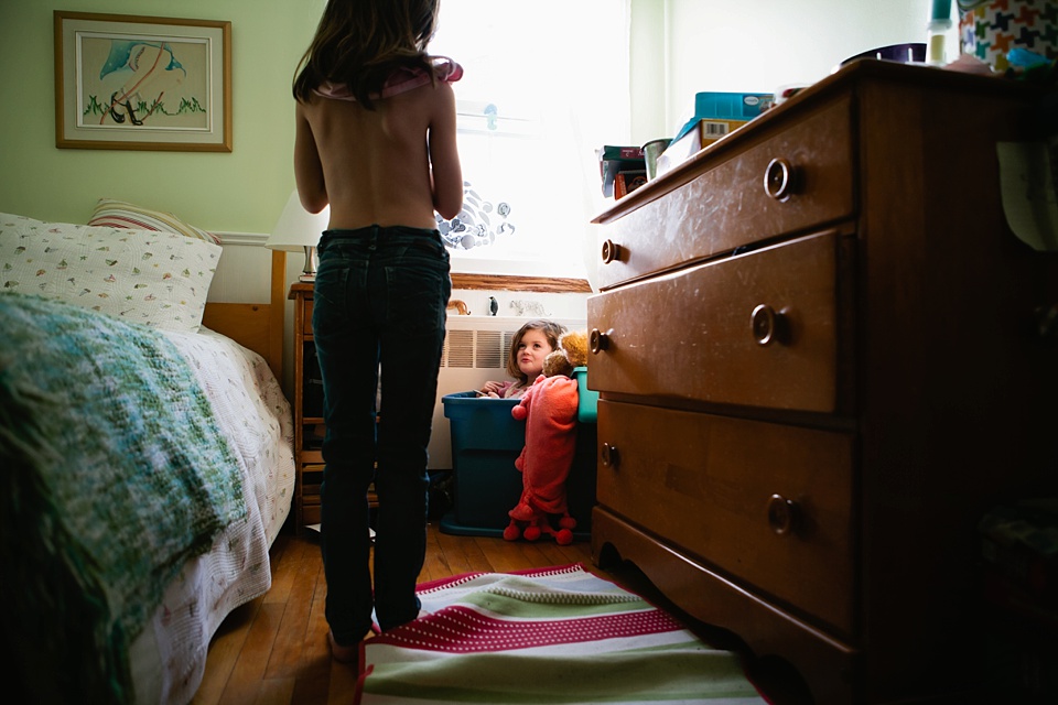 girl in laundry basket - Documentary Family Photography - Sham of the Perfect