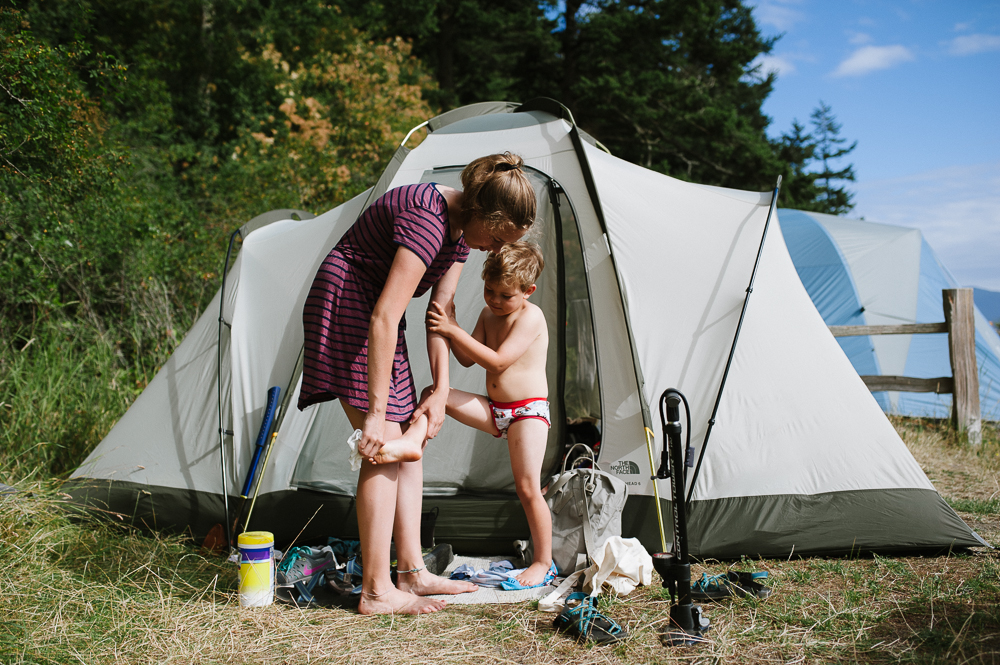 kids wash off near tent - Documentary Family Photography