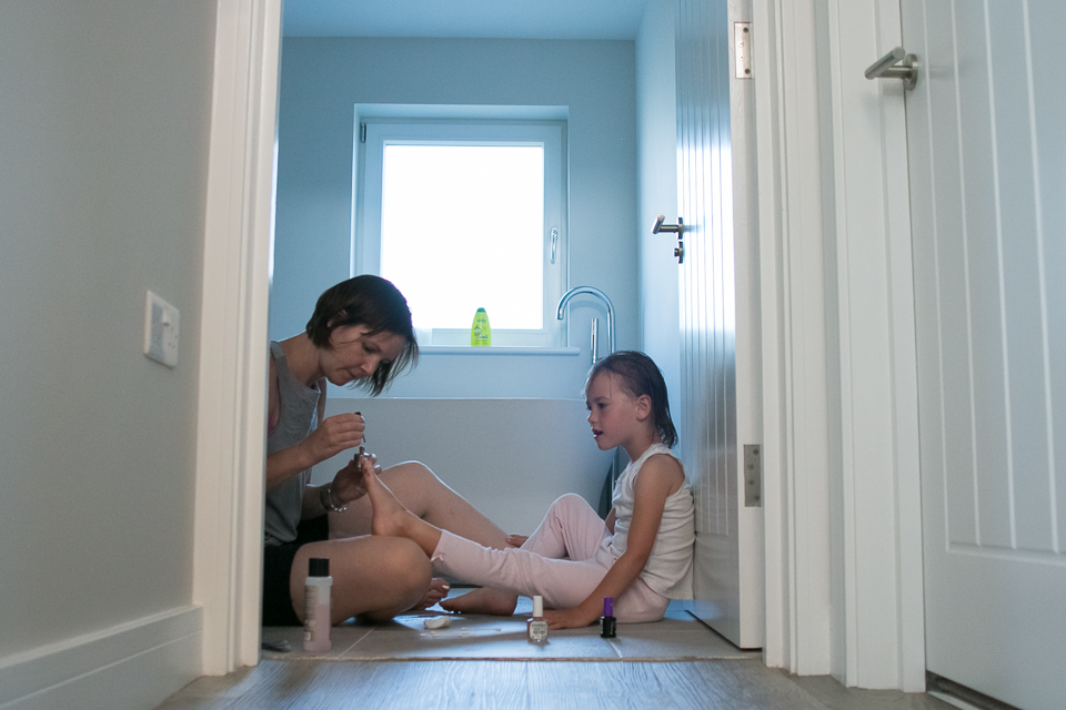 Mom paints daughters toes - Documentary Family Photography