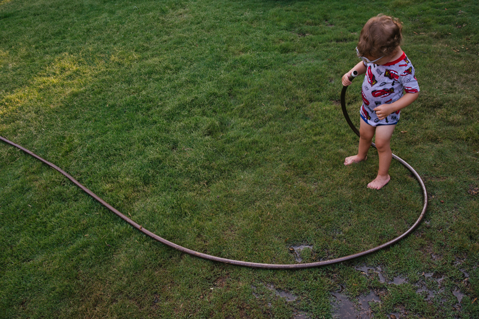 child with garden hose - Documentary Family Photography
