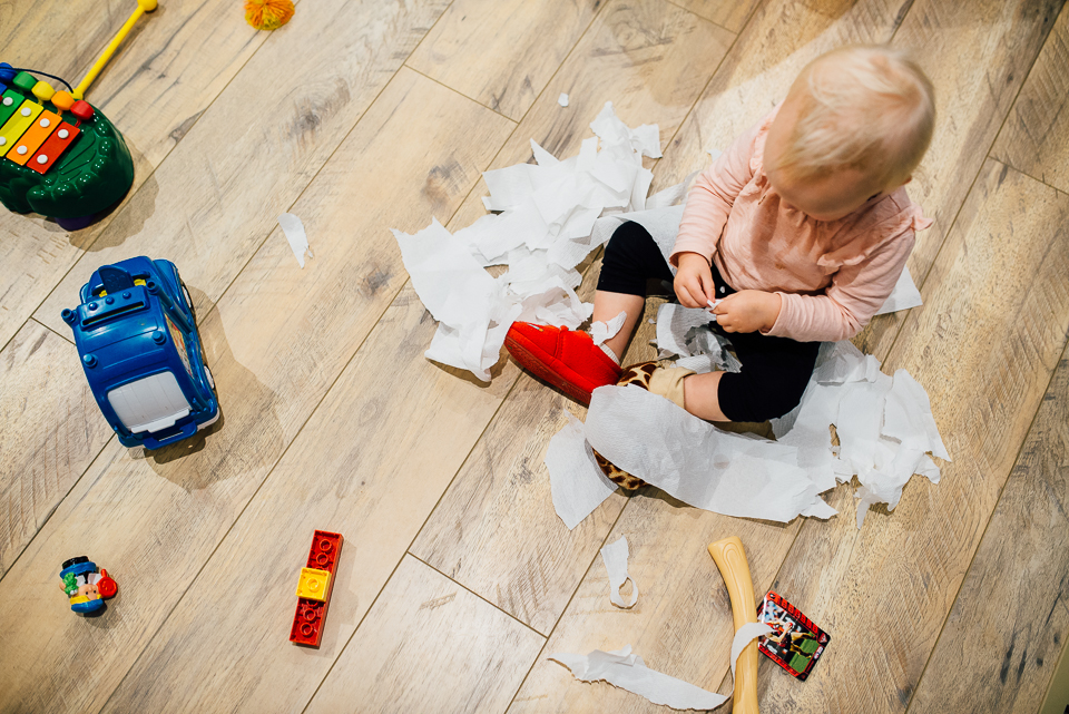 child plays with toilet paper - Documentary Family Photography