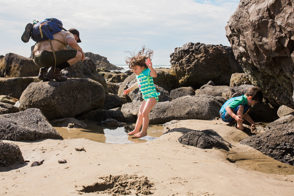 girl jumps in puddle at beach - Documentary Family Photography