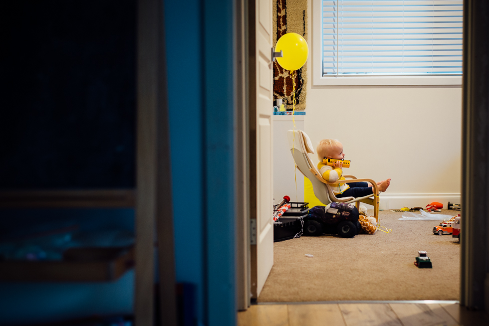 toddler in child size chair - Documentary Family Photography