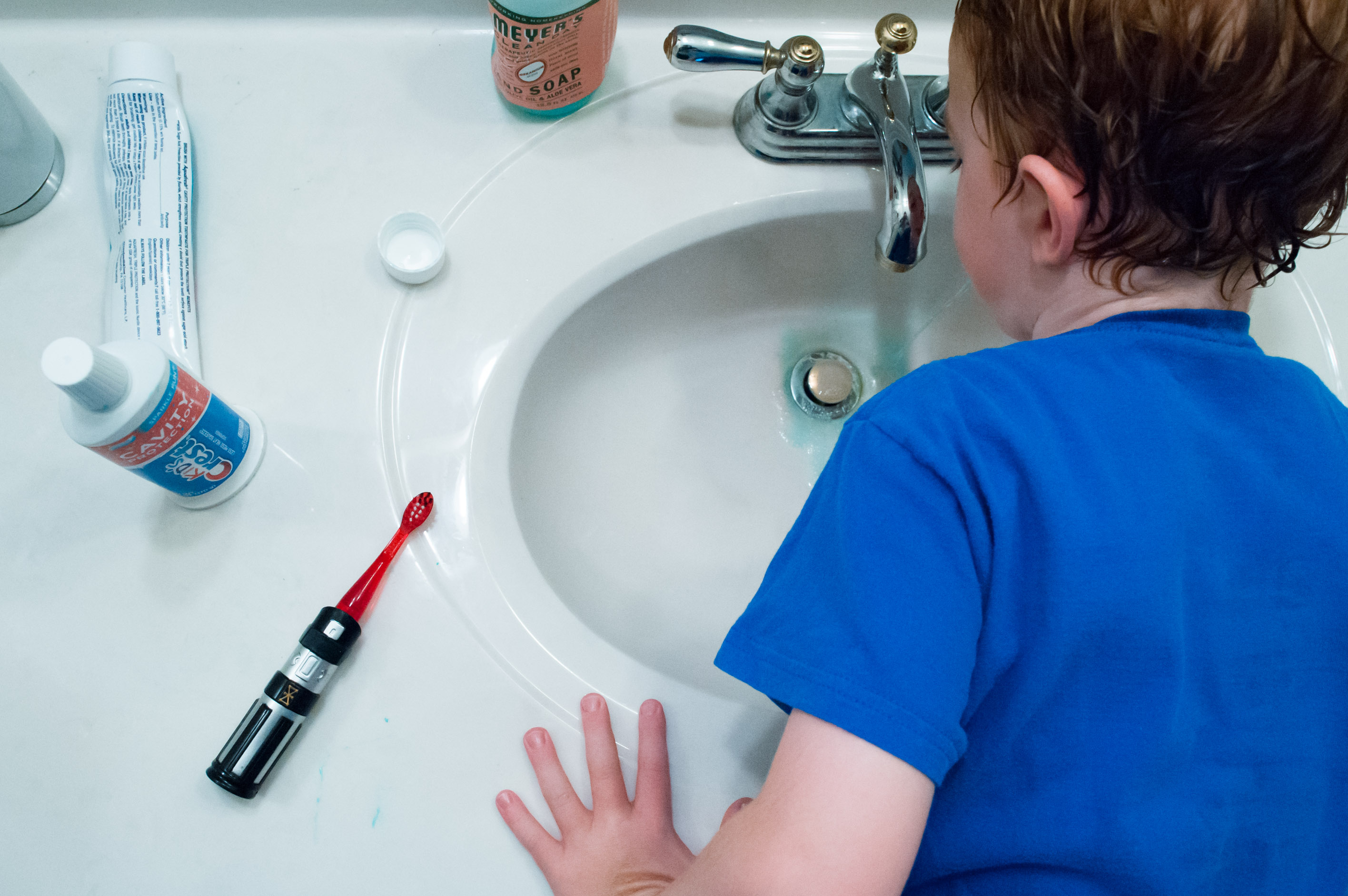 boy brushes teeth - Documentary Family Photography