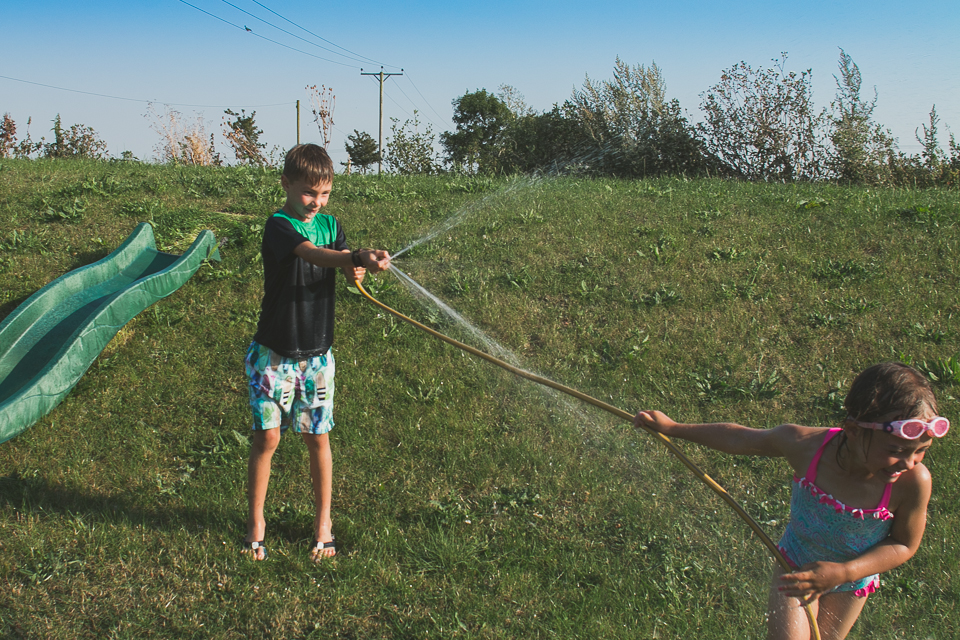 kids play in hose - Documentary Family Photography