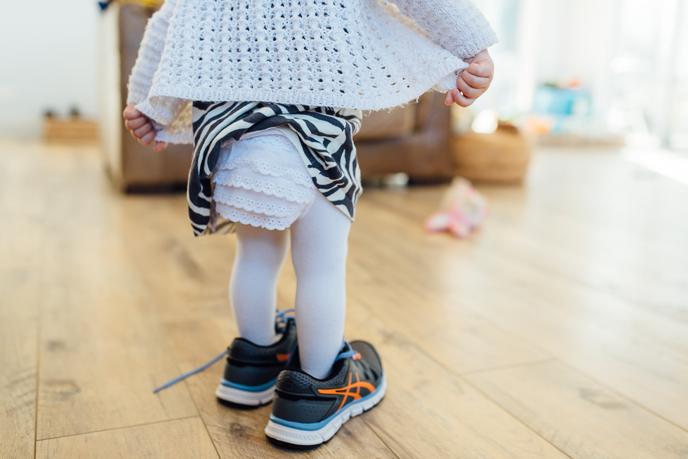 baby in brother's sneakers - Documentary Family Photography