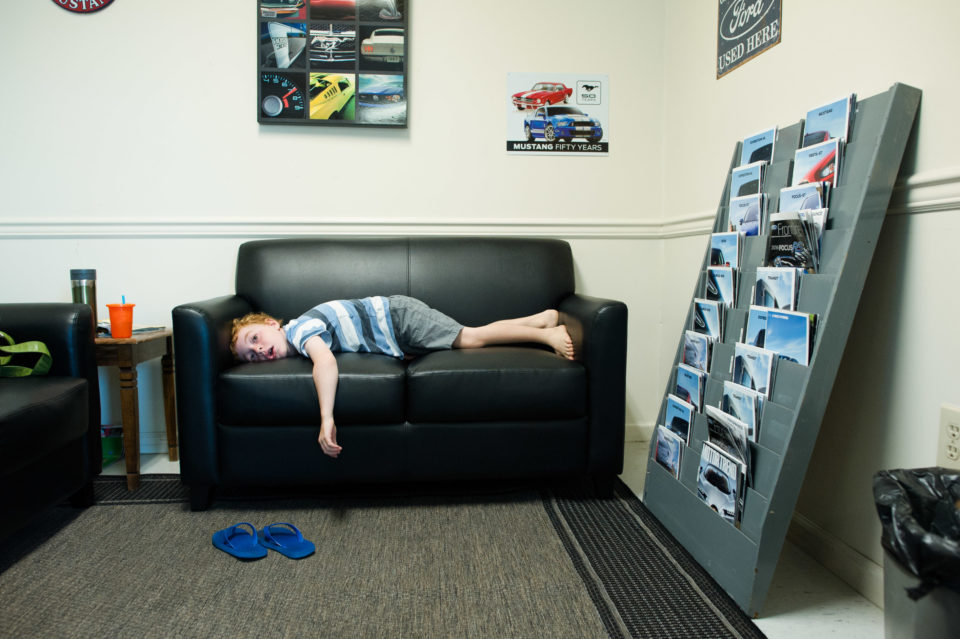 kid bored in waiting room - Documentary Family Photography