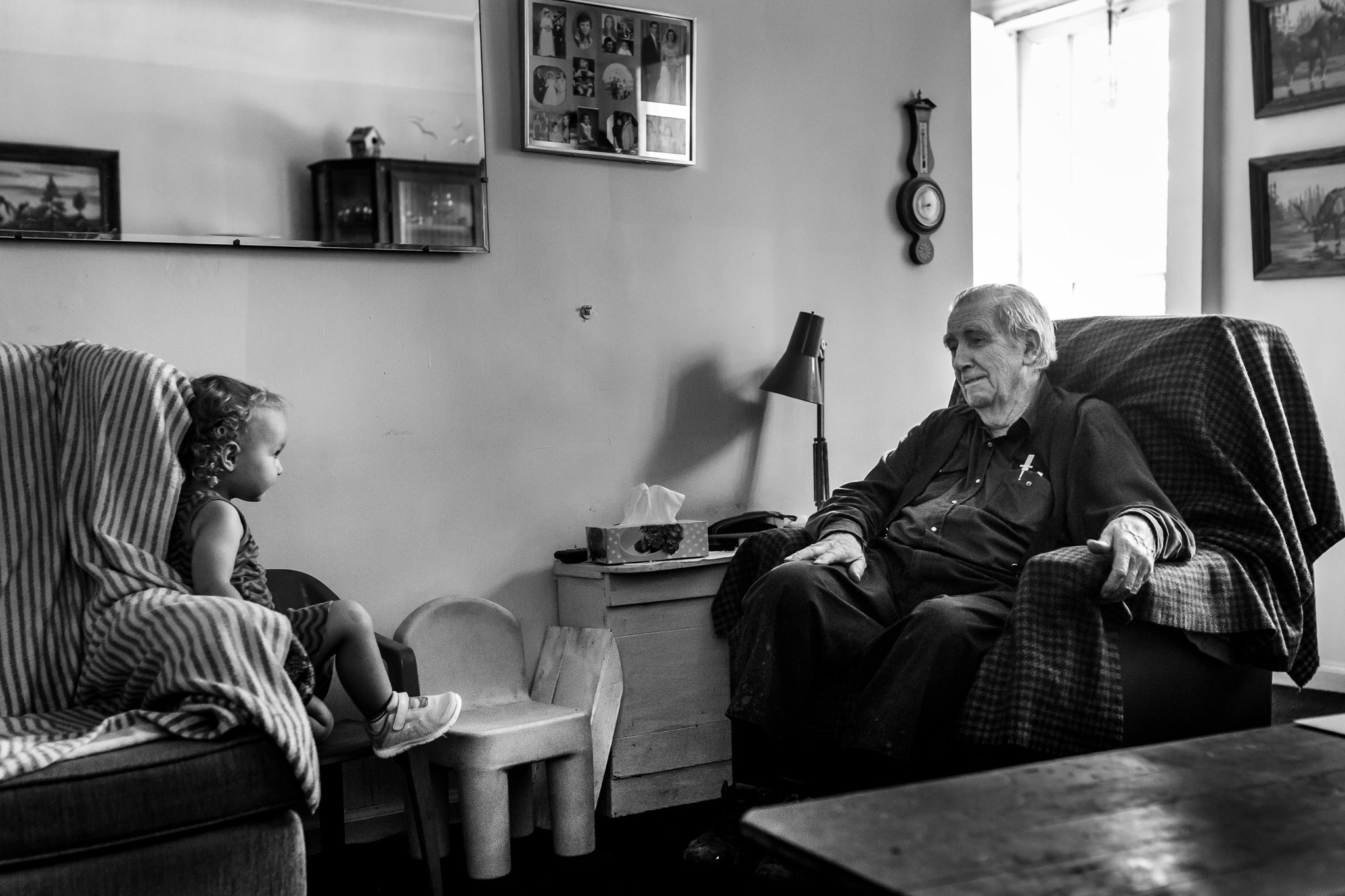 elderly man talks with toddler - Documentary Family Photography