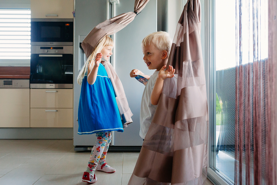 kids play in curtains - Documentary Family Photography