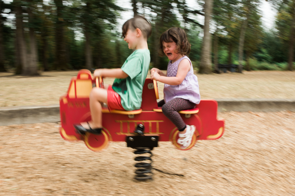 angry child on playground ride - Documentary Family Photography