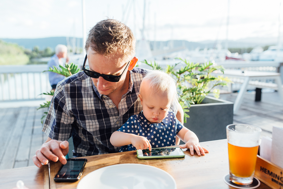 father and baby on smartphones - Documentary Family Photography