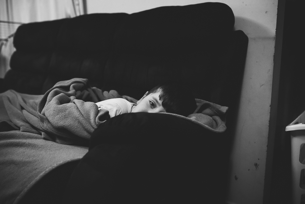 boy laying on couch - Documentary Family Photogarphy
