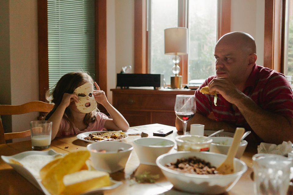 girl makes tortilla mask - Documentary Family Photogarphy