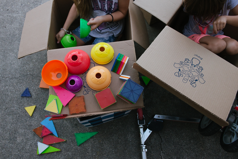 kids play with colored toys and boxes - Documentary Family Photogarphy