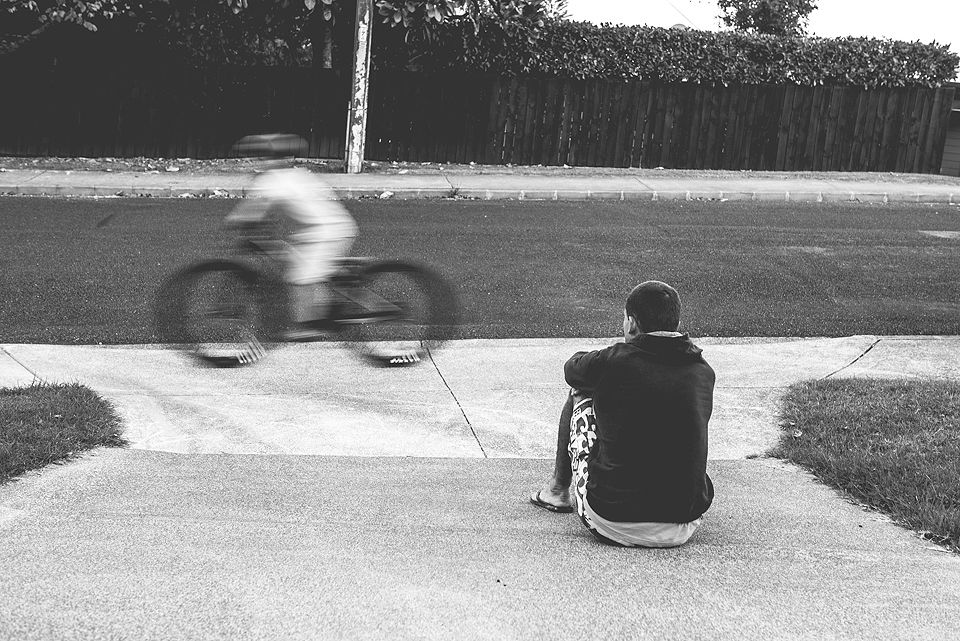 child riding bike as friend watches