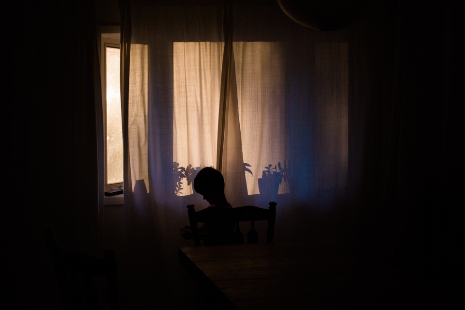 silhouette of child in window - Documentary Family Photography