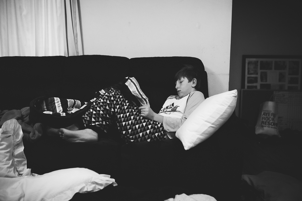child reading on couch - Documentary Family Photography
