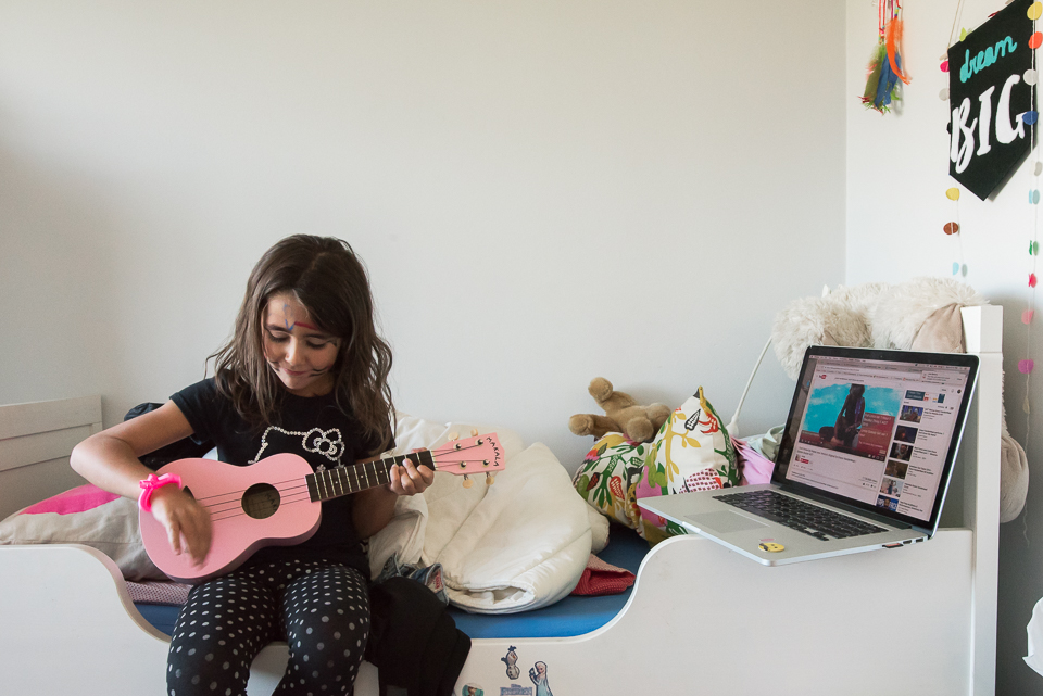 girl playing on pink ukulele - Documentary Family Photography