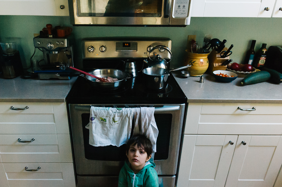 boy waits impatiently for dinner - Documentary Family Photography