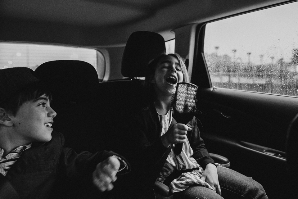 girl singing in backseat - Documentary Family Photography