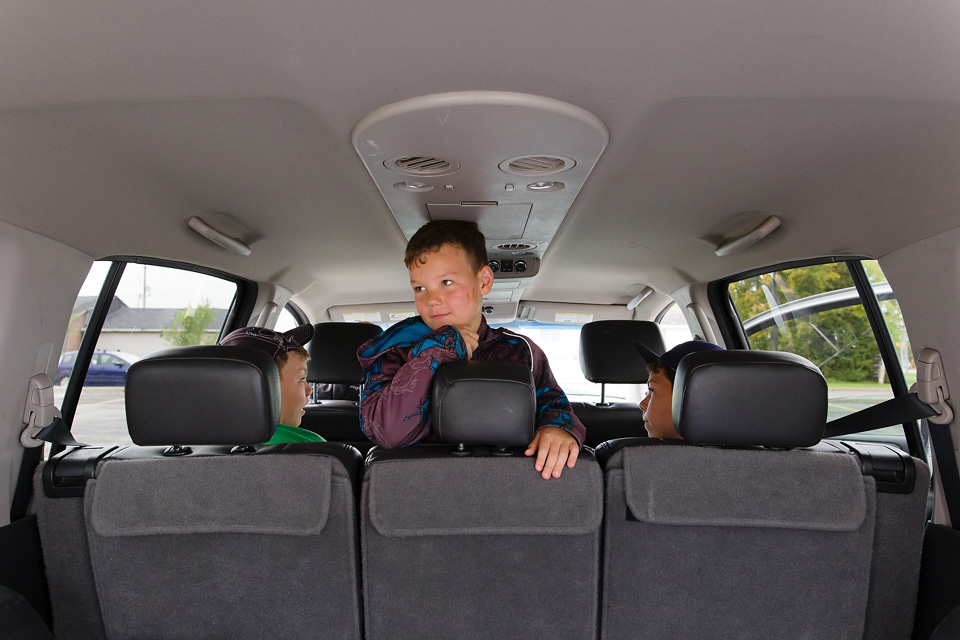 thoughtful boy in backseat - Documentary Family Photography