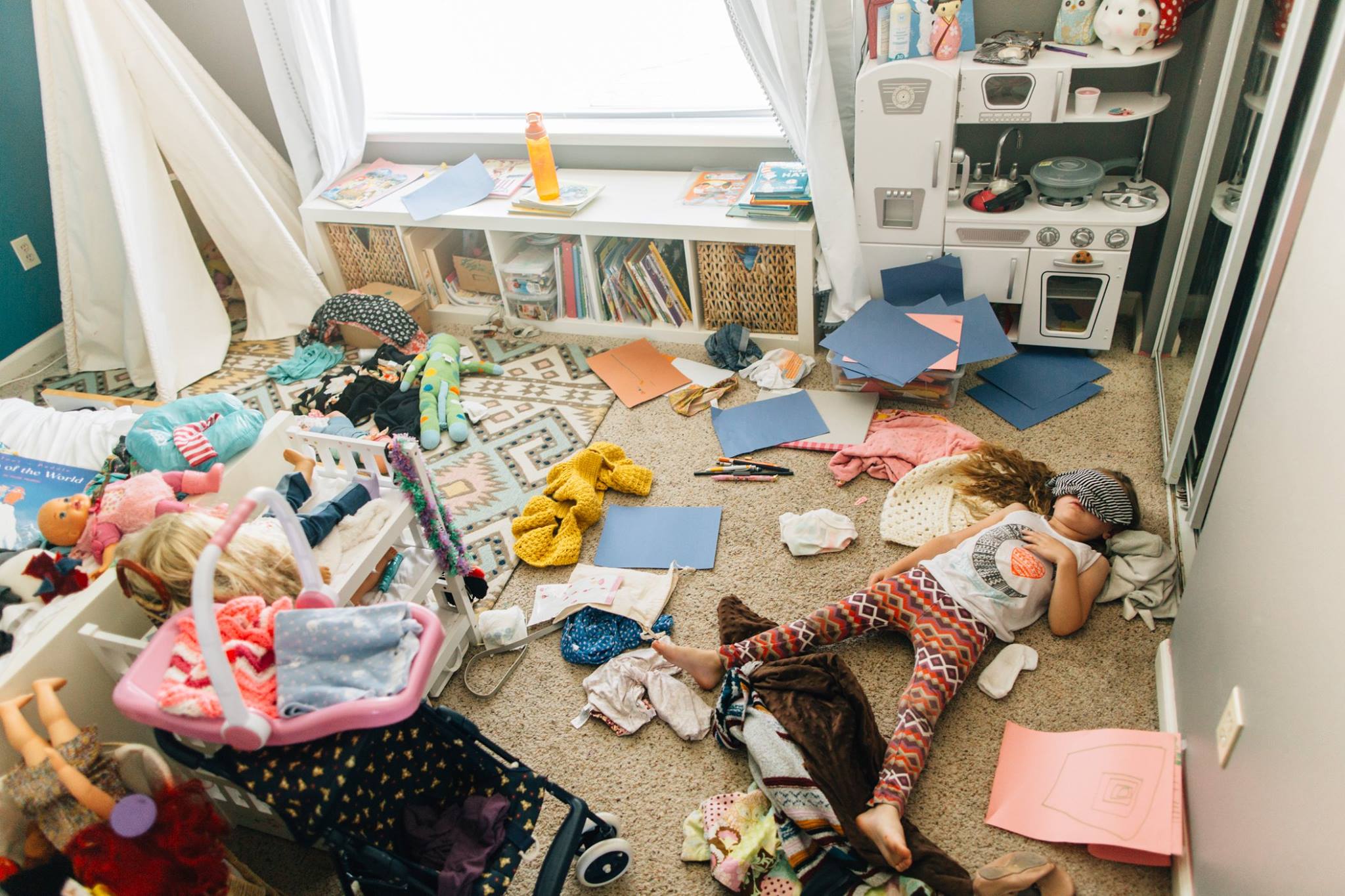 girl asleep on cluttered floor - Documentary Family Photography