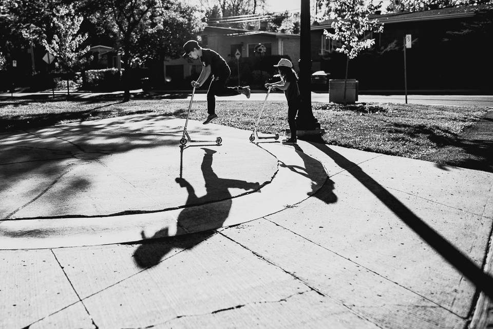 kids and shadows play on scooters - Documentary Family Photography