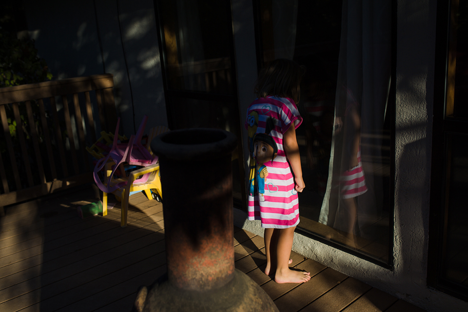 girl and reflection in dappled light - Documentary Family Photography