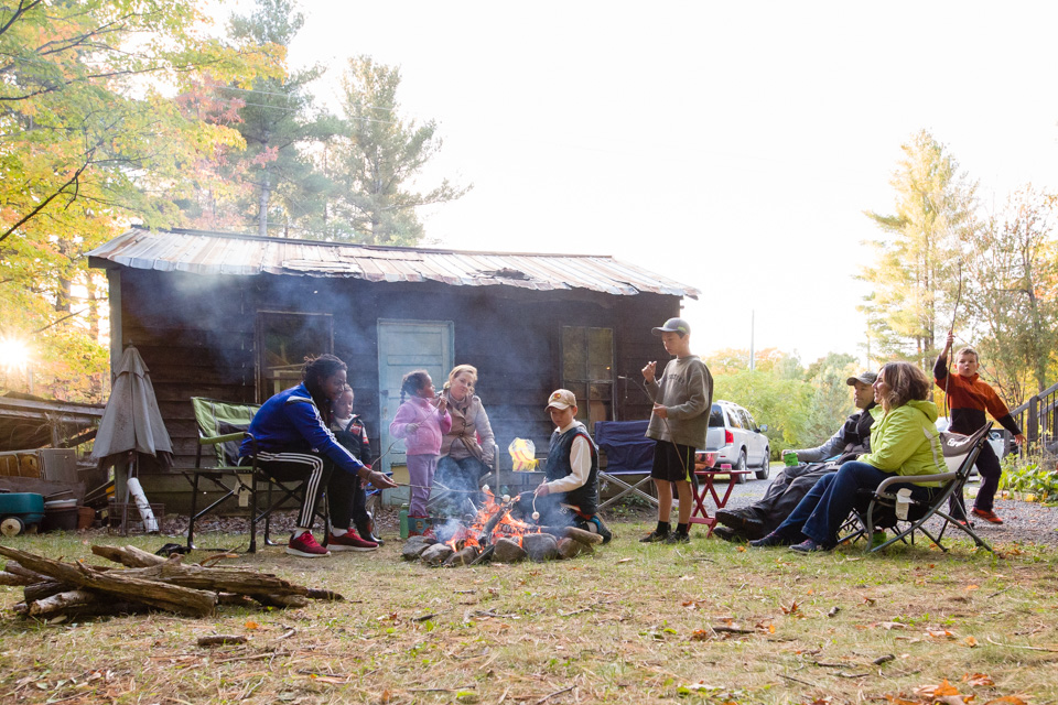 large family around campfire - Documentary Family Photography